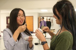 Sophomores Minha Kim and Maria Sottile enjoy cups of ice cream after their last song, "Music from Brave". The Ice Cream Social occurs every year in September.