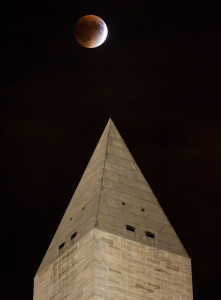 A perigee full moon, or supermoon, is seen behind the Washington Monument during a total lunar eclipse on Sunday, September 27, 2015, in Washington, DC. The combination of a supermoon and total lunar eclipse last occurred in 1982 and will not happen again until 2033.  Photo Credit: (NASA/Aubrey Gemignani)