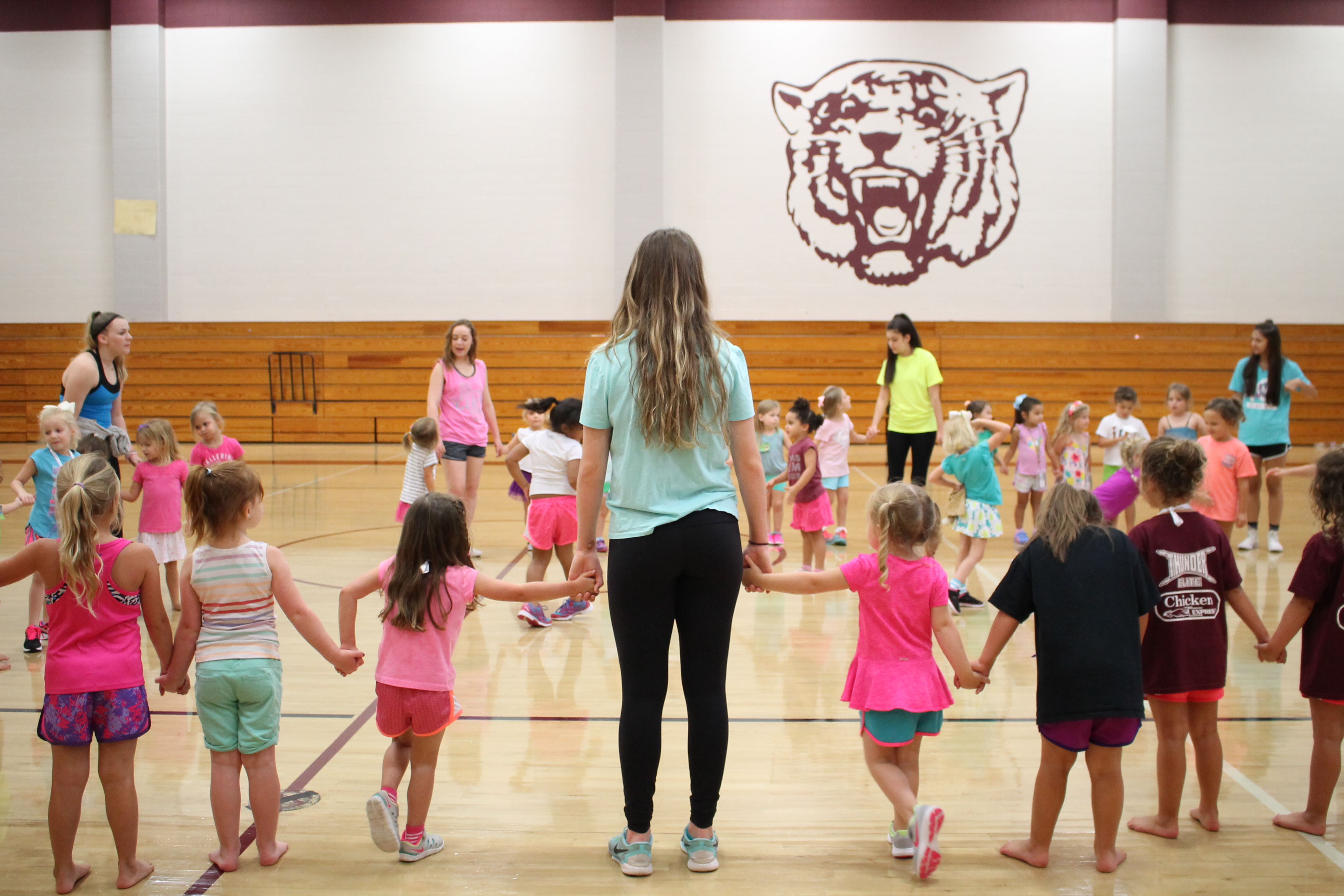 A belle leads the children in a circle activity during the four-day intensive Little Belles' Camp.