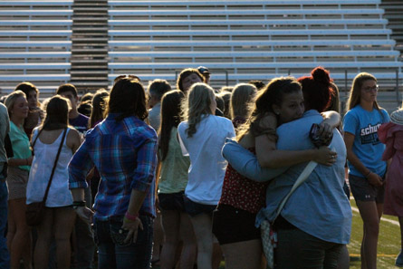 Friends hug at Prayer Vigil for Sydney Jeter